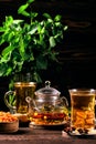 Low key photo of hot herbal tea with sea buckthorn and mint