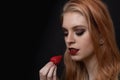 Beautiful long hair young woman is posing with strawberry closeup Royalty Free Stock Photo