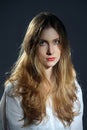 Portrait of dreamy girl in white shirt and jeans with long curly hair Royalty Free Stock Photo