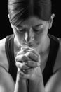 Low key portrait of a faithful woman praying