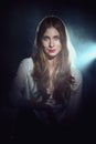 Portrait in mist of dreamy girl in white shirt and jeans with long curly hair Royalty Free Stock Photo