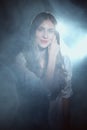 Portrait in mist of dreamy girl in white shirt and jeans with long curly hair Royalty Free Stock Photo