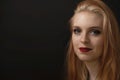 Low key portrait of smiling redhead young woman closeup Royalty Free Stock Photo