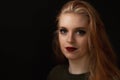 Low key portrait of smiling redhead young woman Royalty Free Stock Photo