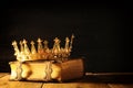 low key of queen/king crown on old book. vintage filtered. fantasy medieval period Royalty Free Stock Photo