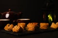 A low key and selective focus picture of Arabic baklava on slate plate with cup, teapot and lantern insight.