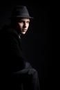 Low key shot of young man in hat Royalty Free Stock Photo