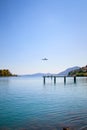 low landing approach of an airplane over a sea bay to Corfu airport over a platform Royalty Free Stock Photo