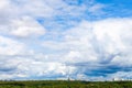 low large white clouds in blue sky over city park Royalty Free Stock Photo