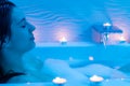 Low light ambient portrait of woman enjoying foam bath.