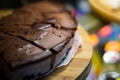 Low light photo some pieces of fresh pie in confectionery fridge on blurred background. Close-up view