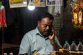 Low light portrait of an Indian shopkeeper