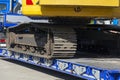 Low loader trailer with crawler excavator, close-up