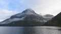 Low lying clouds across the mountains at Lake Manapouri in New Zealand