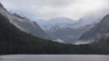Low lying clouds across the mountains at Lake Manapouri in New Zealand