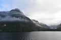 Low lying clouds across the mountains at Lake Manapouri in New Zealand