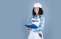 Low maintenance. engineer hold folder. young female worker on gray background. repair and renovation. woman wear Royalty Free Stock Photo