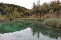Landscape lake and mountains, reflection in the water of the lake of rocks and trees on an autumn day, Plitvice Lakes National Par Royalty Free Stock Photo