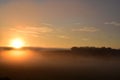 low orange sunrise above morning fog Royalty Free Stock Photo