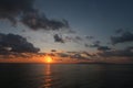 Low orange sunset in dramatic clouds over ocean in Indonesia Royalty Free Stock Photo