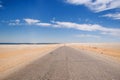 Low perspective road in the desert of fayoum egypt. Straight road towards the horizon with lake on the left. Royalty Free Stock Photo