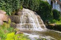 Low perspective view of small waterfall with pond near place called Ancient Ruins in the Arboretum Alexandria in Bila Tserkva