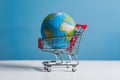 Low poly global depicted on white background within shopping cart