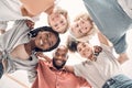 Low portrait of a group of five cheerful diverse businesspeople standing together in an office at work. Happy business