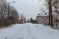 Low-rise buildings in Russia. Unclean road. A lot of snow.