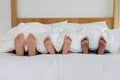 Mother and children sleeping barefoot in bed in bedroom at home Royalty Free Stock Photo