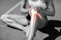 Low section of athlete suffering from knee pain