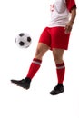 Low section of biracial young female soccer player juggling soccer ball with foot