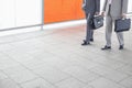 Low section of businessmen with briefcase walking in railroad station