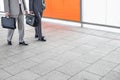 Low section of businessmen with briefcase walking in railroad station