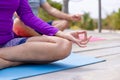 Low section of caucasian senior couple practicing meditation while doing yoga at tourist resort