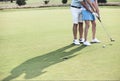 Low section of couple playing golf