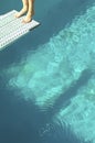 Low Section Of A Diver Standing Backwards On Diving Board Over Pool Royalty Free Stock Photo