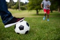 Low section of father and son playing football