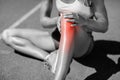 Low section of female athlete suffering from joint pain