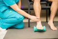 Therapist Assisting Patient To Use Foot Roller For Plantar Fasciitis