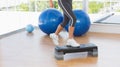 Low section of a fit woman performing step aerobics exercise Royalty Free Stock Photo