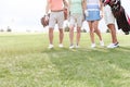 Low section of friends standing at golf course