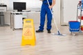 Janitor Cleaning Floor With Mop In Office Royalty Free Stock Photo