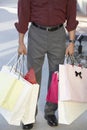 Low Section Of A Man Holding Shopping Bags