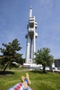 Low section of man relaxing in front of Zizkov Television Tower in Prague, Czech Republic Royalty Free Stock Photo