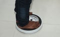 Low Section Of Man Standing On Weighing Scale Royalty Free Stock Photo