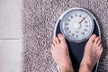 Low section of man standing on weight scale Royalty Free Stock Photo