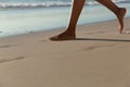 Low section of mixed race woman on beach practicing yoga durning sunset Royalty Free Stock Photo