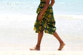 Low section woman walking barefoot along the seashore Royalty Free Stock Photo