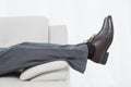 Low section side view of a businessman resting on sofa Royalty Free Stock Photo